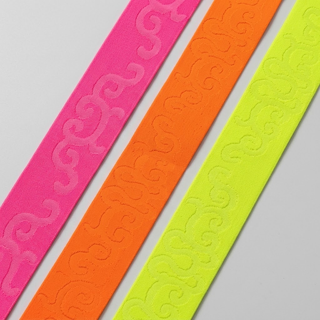 ELAST-FANT-0000015-50MM Galon élastique fantaisie de 50 mm en tissage jacquard ton sur ton à motifs volutes gravées, coloris fluo vifs à forte tenue indéformable ne roulant pas, conçu pour ceintures apparentes, jupes, pantalons et customisation d'accessoires textiles.